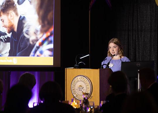 young woman speaking at a podium